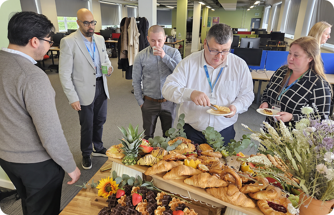 Colleagues sharing food together in the VidAlert office