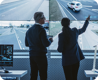 Engineers installing an enforcement camera on street infrastructure