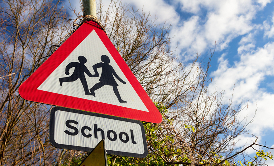 School warning sign beside an enforced school street