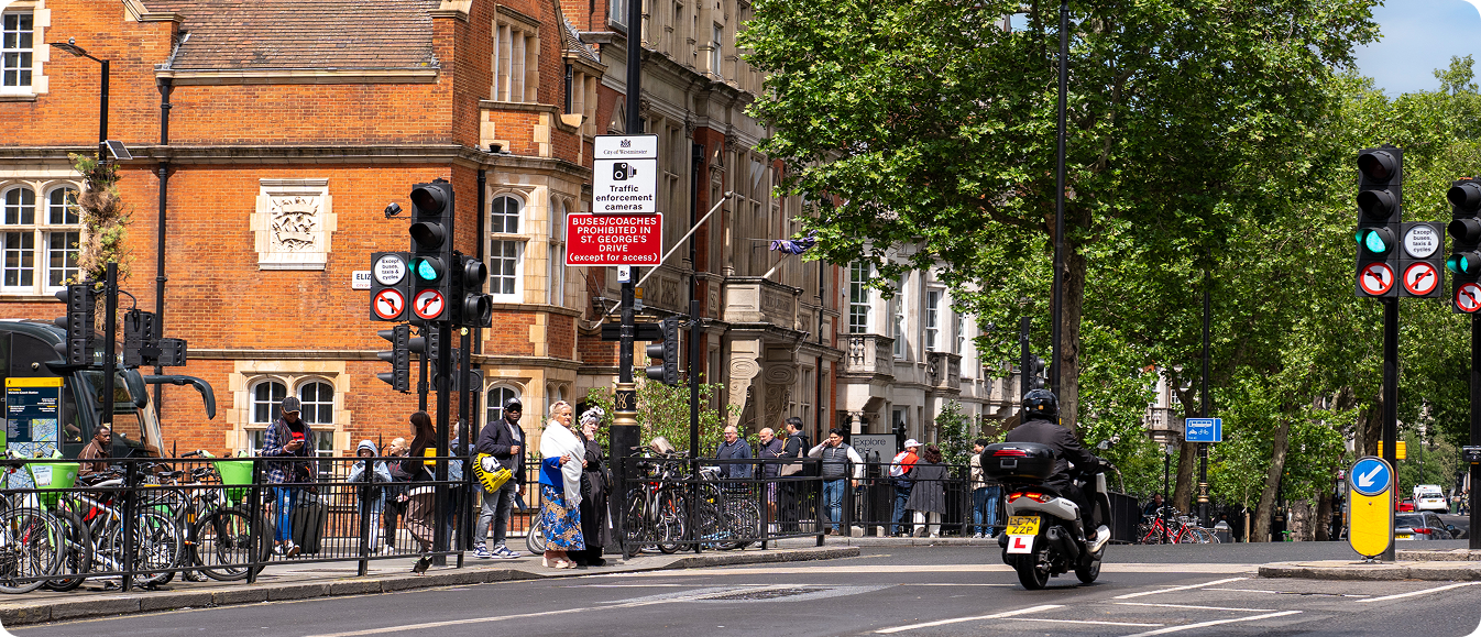 Traffic and cyclists moving through a monitored school street junction